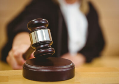 Hand about to bang gavel on sounding block
